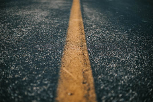 Close up of a yellow line painted on the road