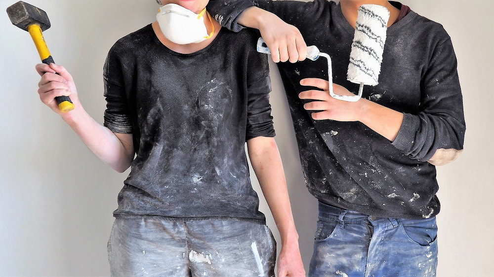 image of a man and womans torso in decorating clothes holding decorating tools